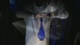 bleu drop-shaped glass bottles on a white table.